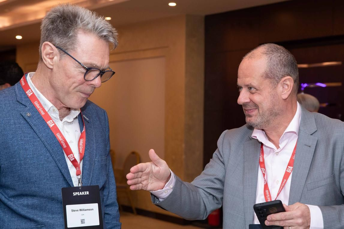 Two conference attendees exchanging ideas during a professional event
