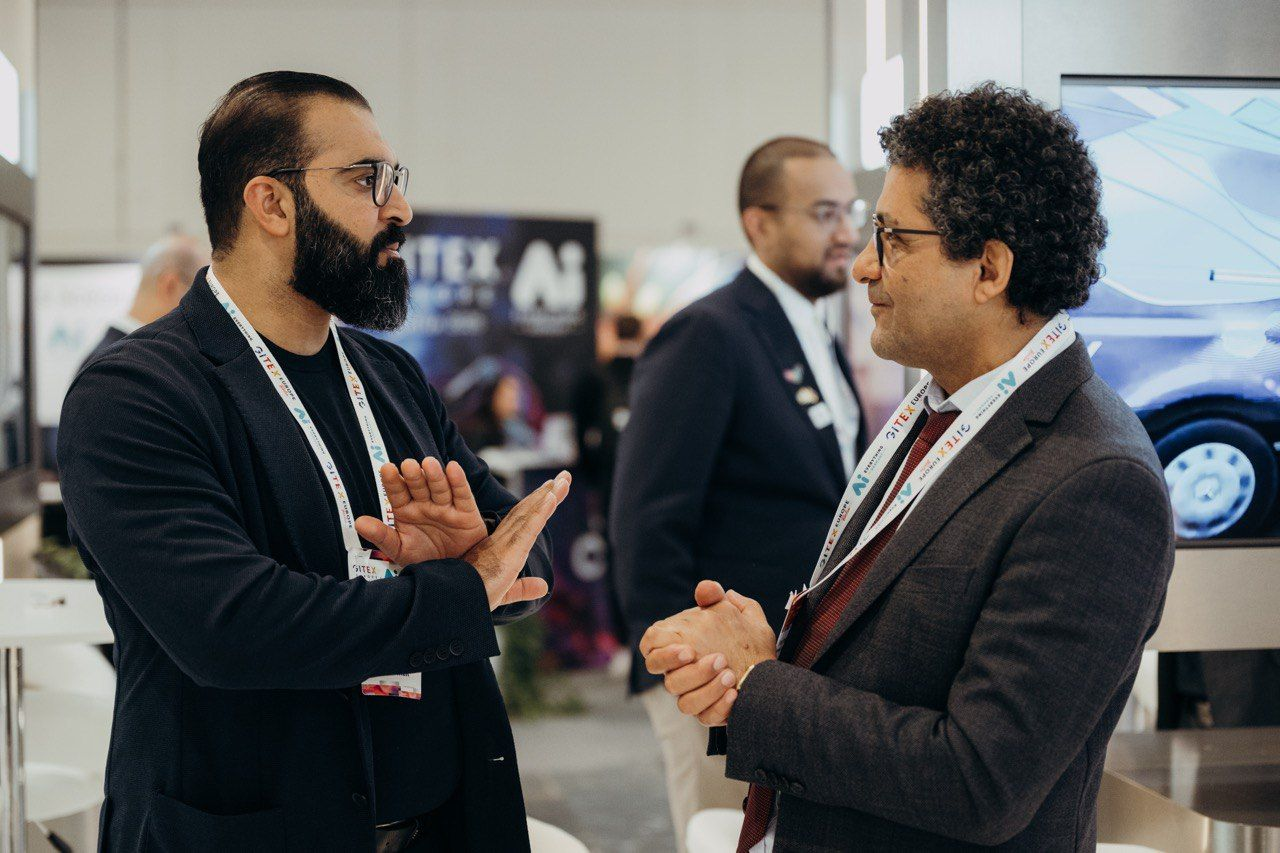 Two security professionals discussing technology at an exhibition